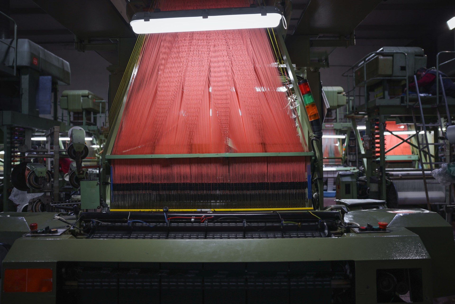 Colorful Threads on a loom in weaving loom machine in textile factory